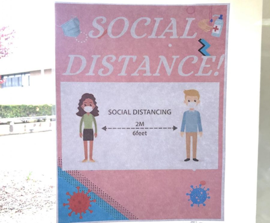 A poster in the SWR HS lobby reminding people to maintain social distance.