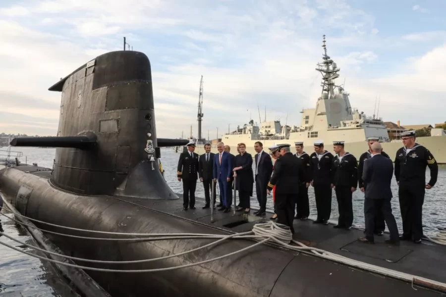 French President Emmanuel Macron (2nd L) and Australian Prime Minister Malcolm Turnbull (3rd L) stand on the deck of HMAS Waller, a Collins-class submarine operated by the Royal Australian Navy, at Garden Island in Sydney on May 2, 2018. - Macron arrived in Australia on May 1 on a rare visit by a French president with the two sides expected to agree on greater cooperation in the Pacific to counter a rising China. (Photo by LUDOVIC MARIN/POOL/AFP via Getty Images)
