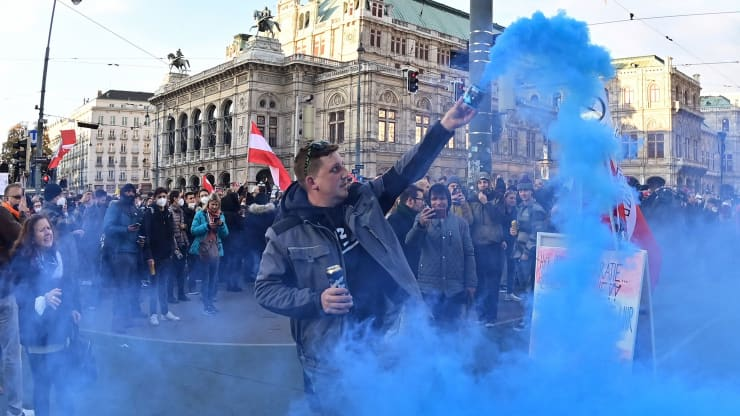 A member of Austrias far-right freedom party lighting a smoke bomb during a demonstration.