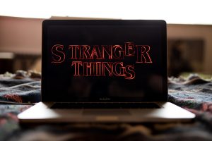 Laptop featuring the title for the Netflix series Stranger Things.